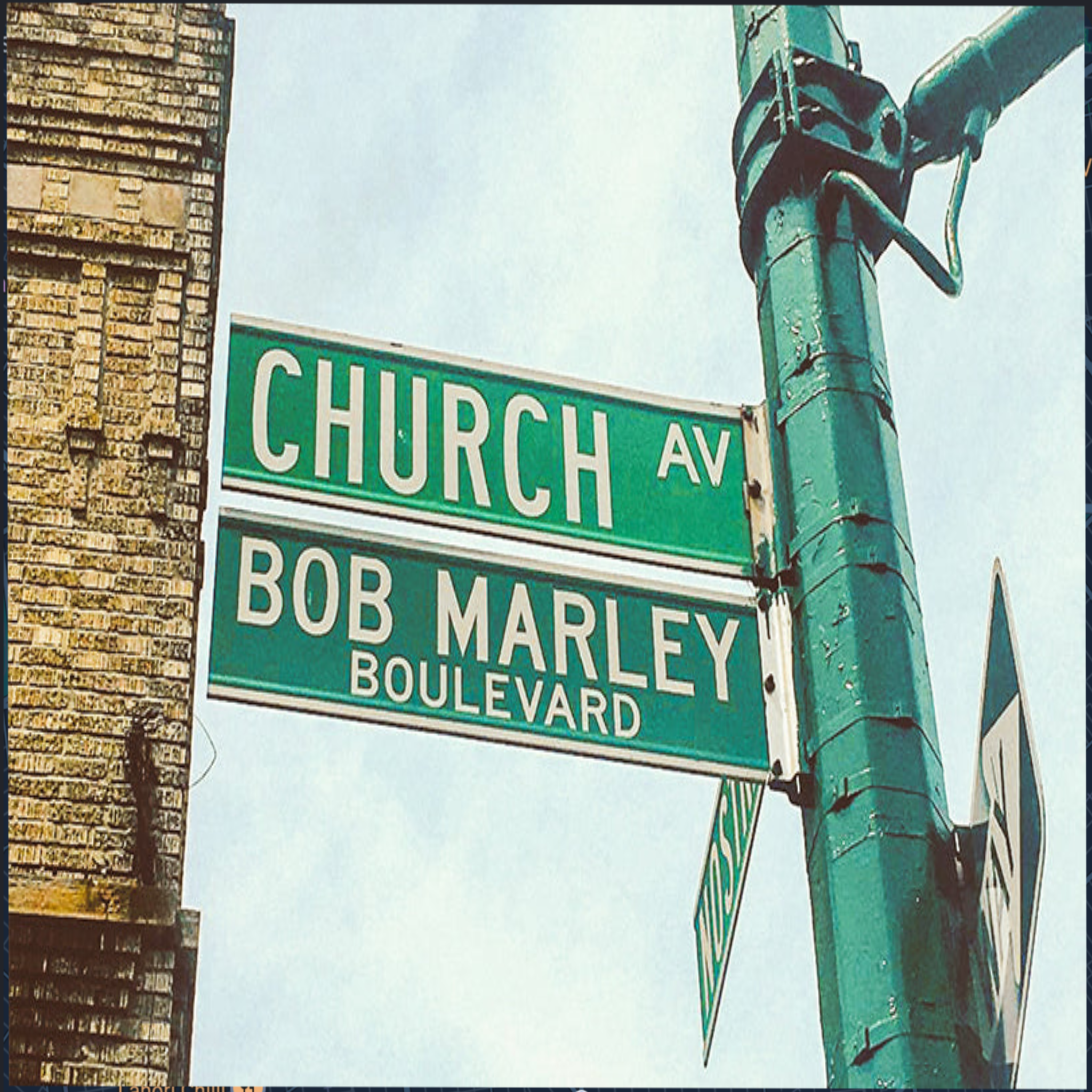 Street sign for Church Ave and Bob Marley Boulevard with a building in the background.