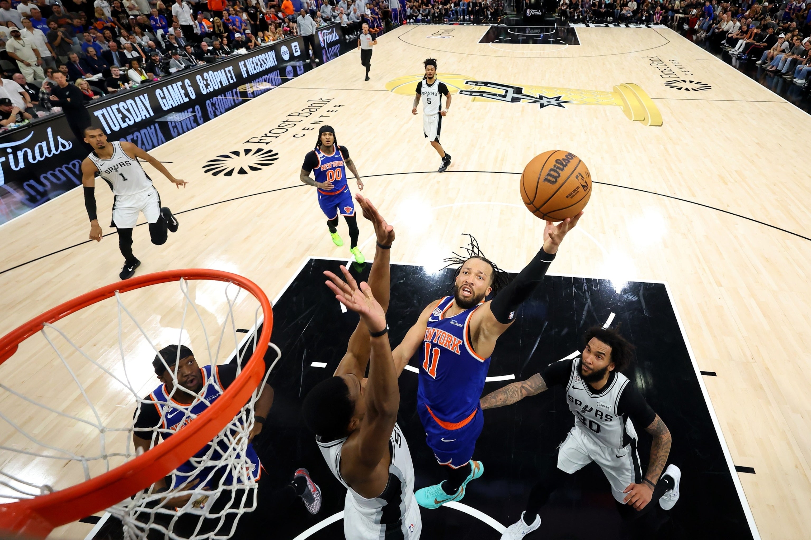 Basketball game in progress with players on the court