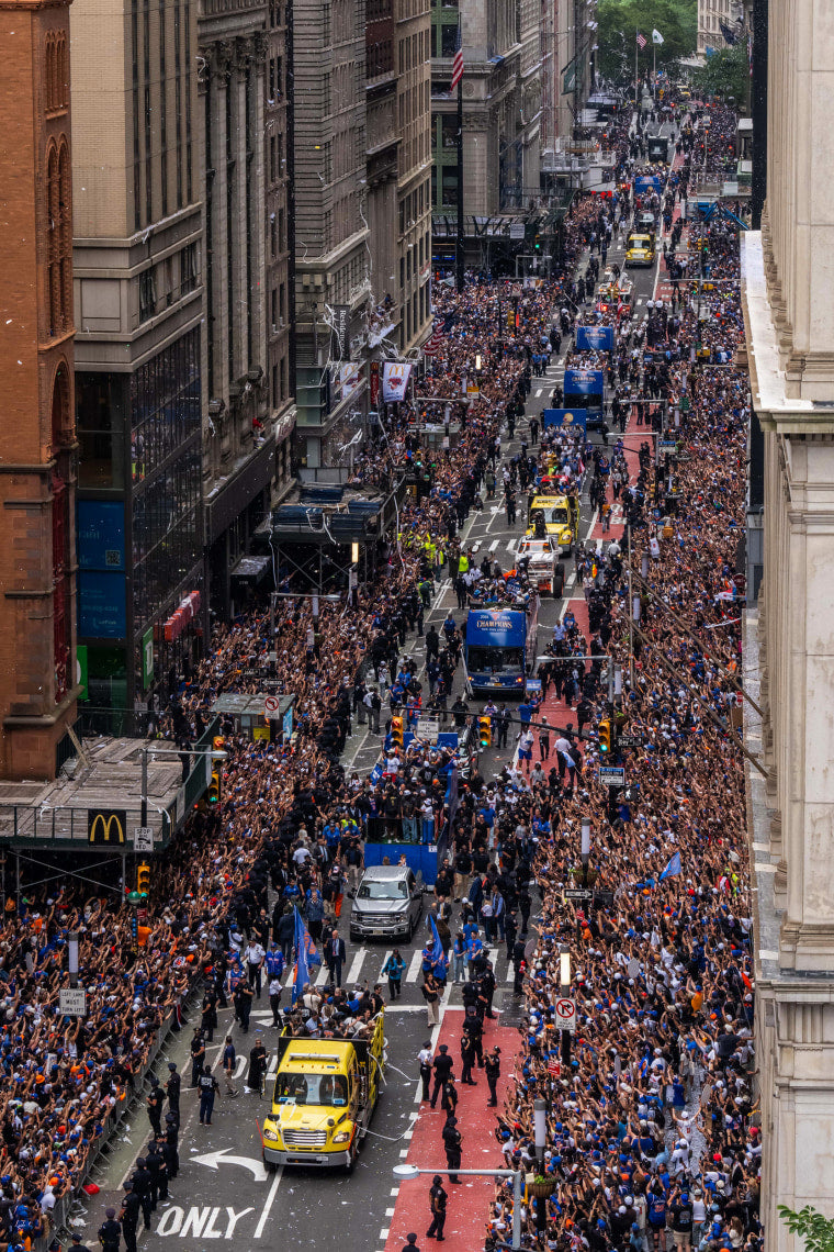 Massive crowd of people on a city street, likely during a parade or public event.