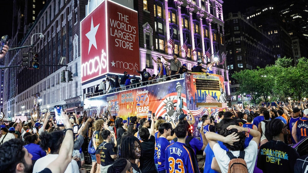 Massive Macys Thanksgiving Day Parade float with 'The World's Largest Store' sign, surrounded by a crowd of people.