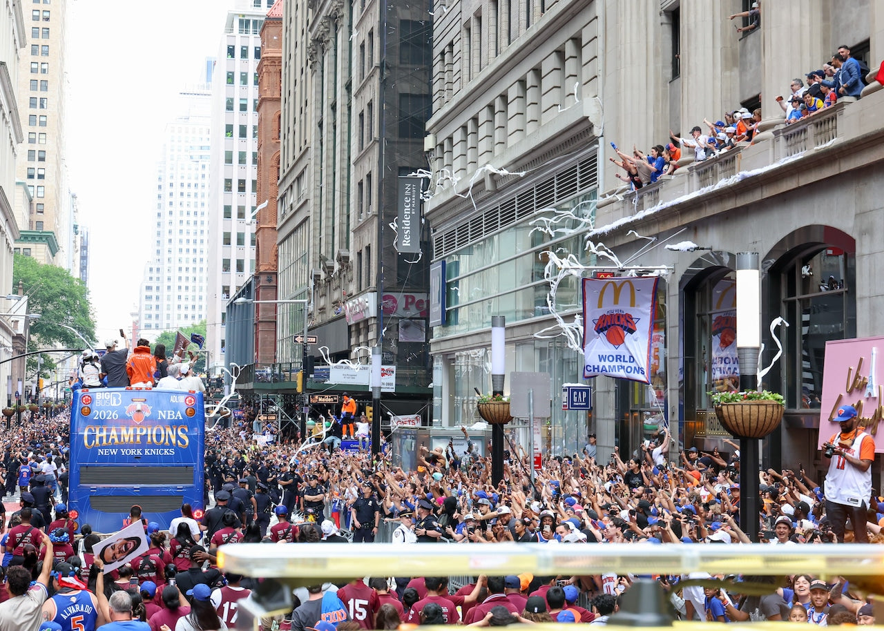 Parade with floats and cheering crowd in a city street